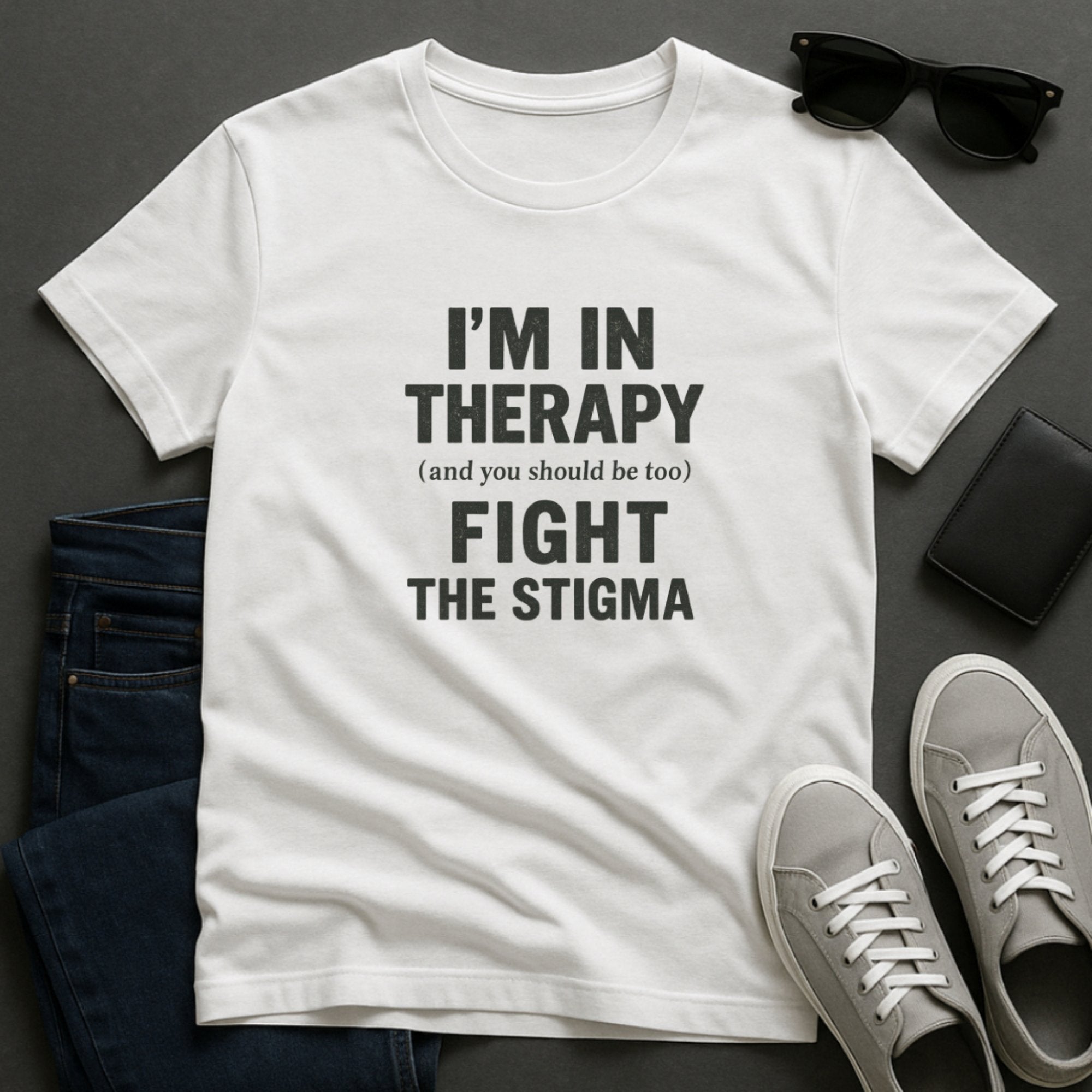 White mental health awareness t-shirt with bold typography saying “I’m In Therapy, Fight the Stigma,” promoting openness, support, and normalization of therapy