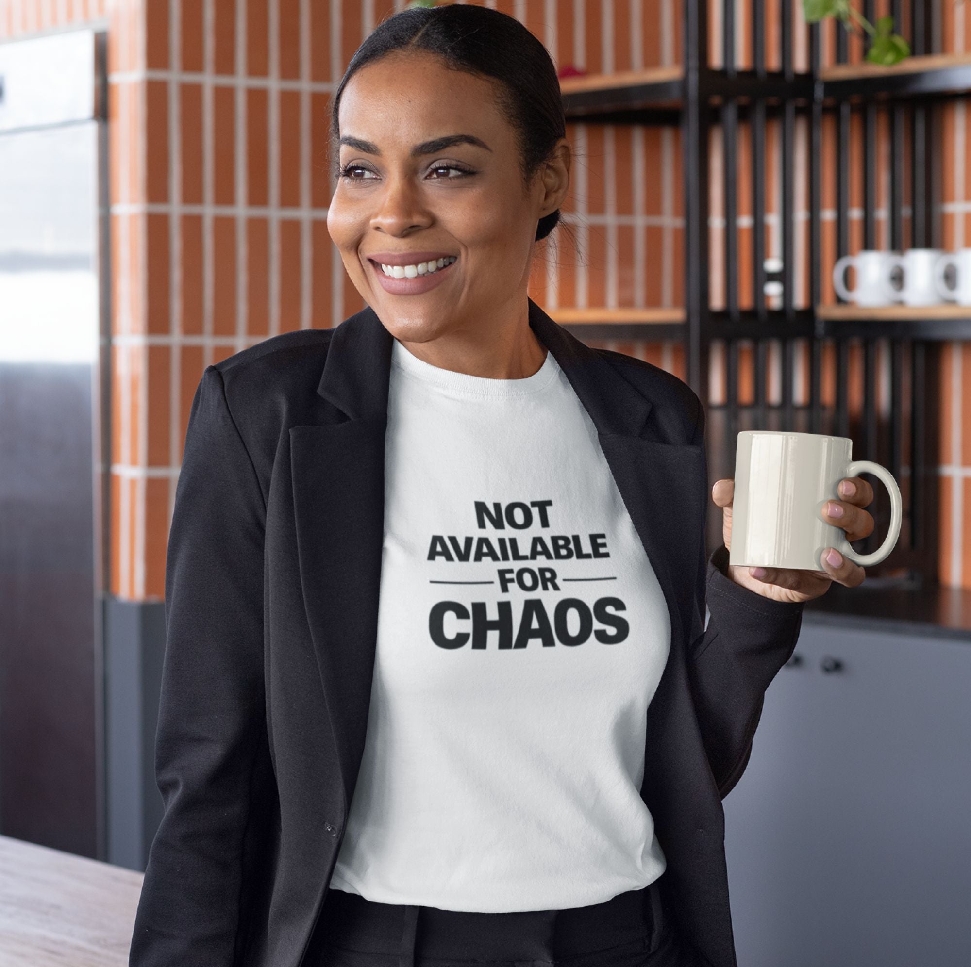 Woman holding a mug with 'Not Available for Chaos' text in a kitchen setting