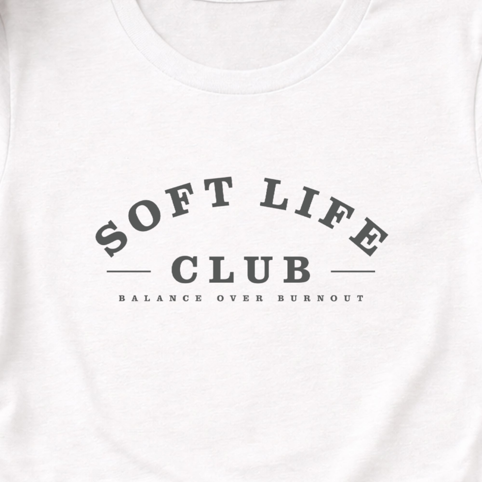 White t-shirt with 'SOFT LIFE CLUB' text on a white background