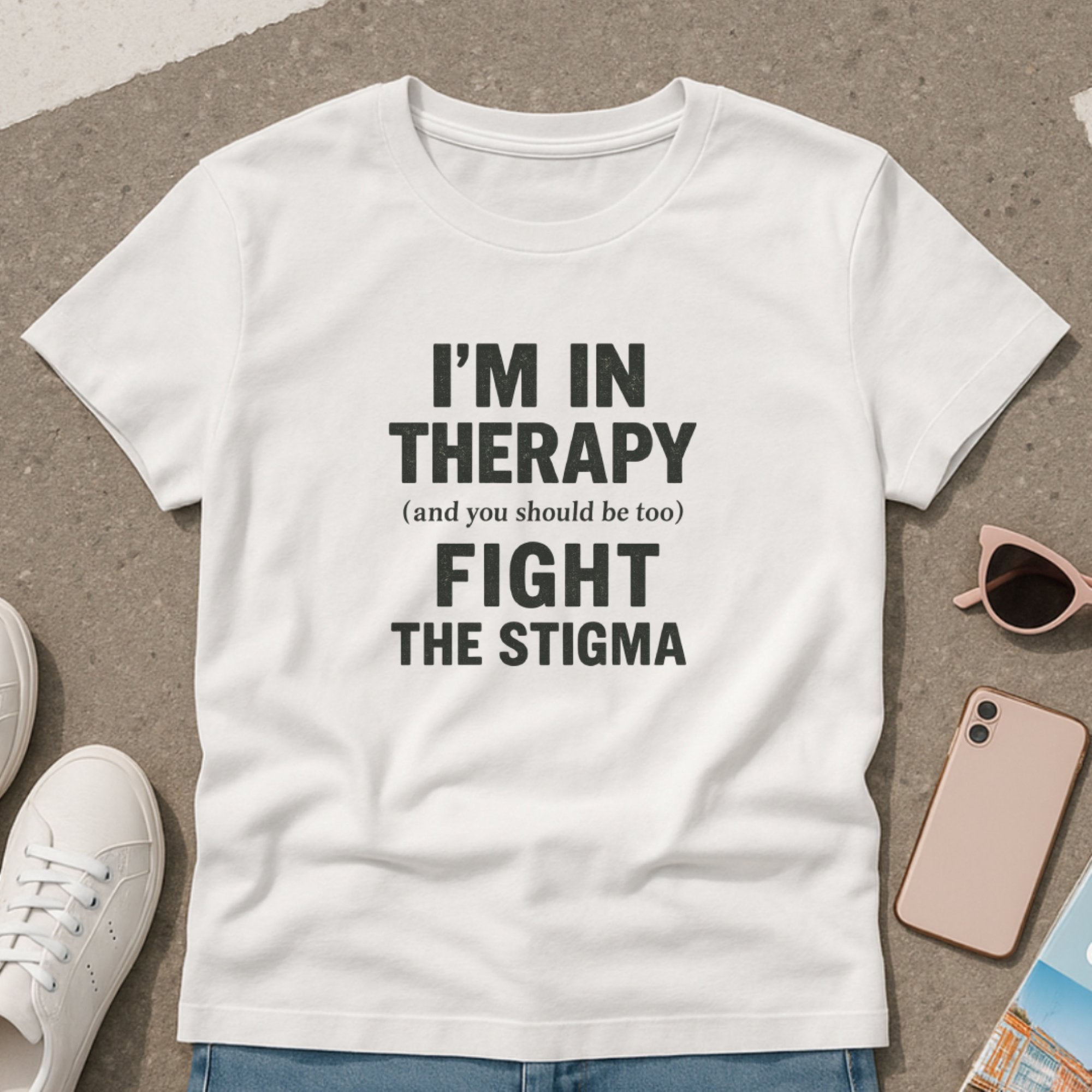 White mental health awareness t-shirt with bold typography saying “I’m In Therapy, Fight the Stigma,” promoting openness, support, and normalization of therapy