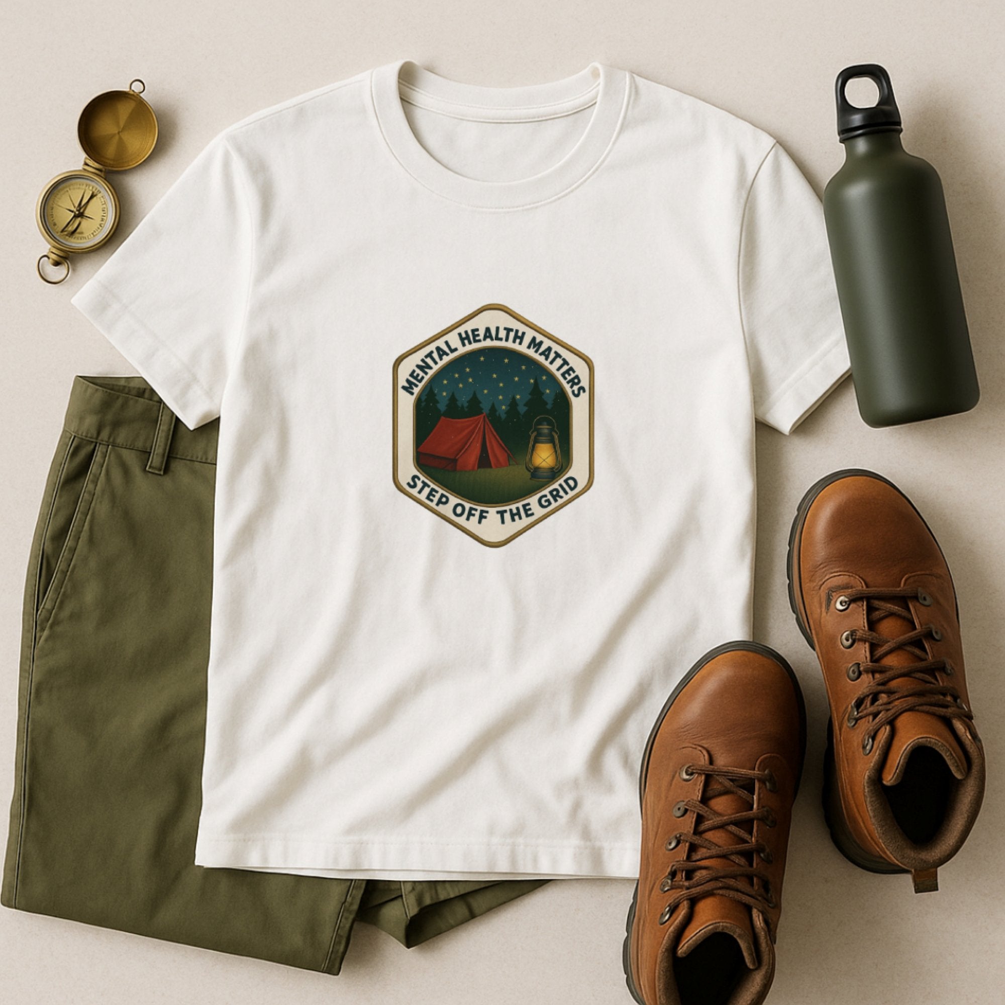 White “Mental Health Matters – Step Off The Grid” t-shirt featuring a peaceful camping scene with a tent, lantern, and starry forest night sky, encouraging rest, grounding, and time away to reset